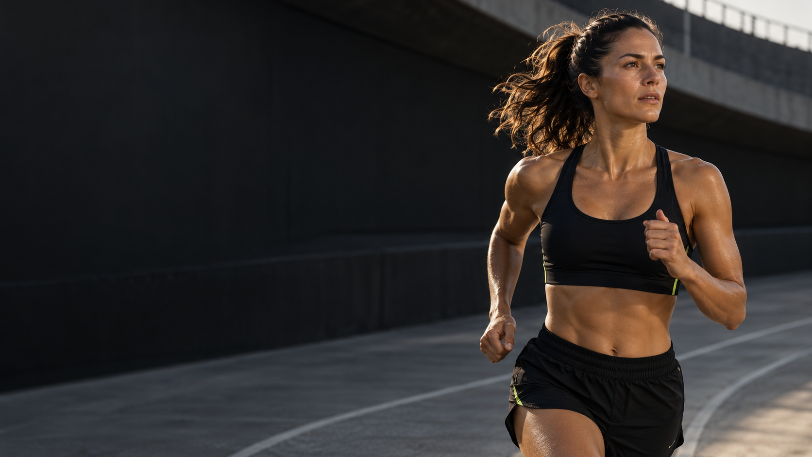 An athlete running with focus on an outdoor track